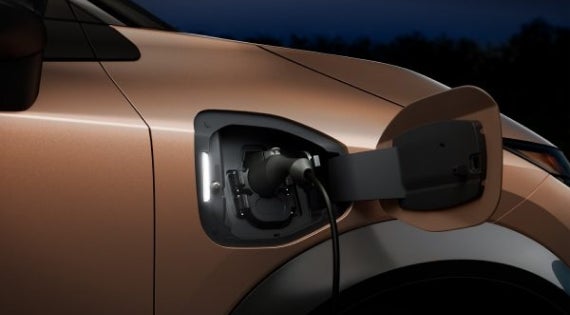 Close-up image of charging cable plugged in | Tony Serra Highland Nissan in Highland MI